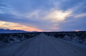 Sunset over a sand road in the desert