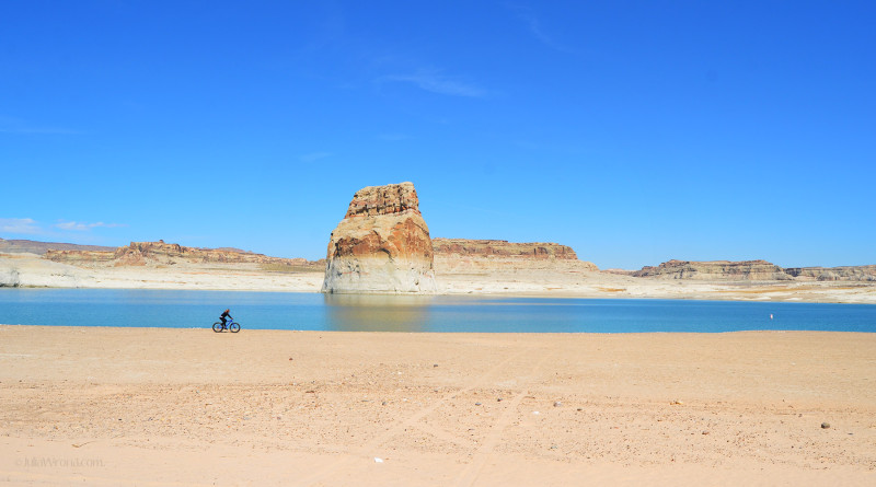 Bicyclist on beach in Lake Powell